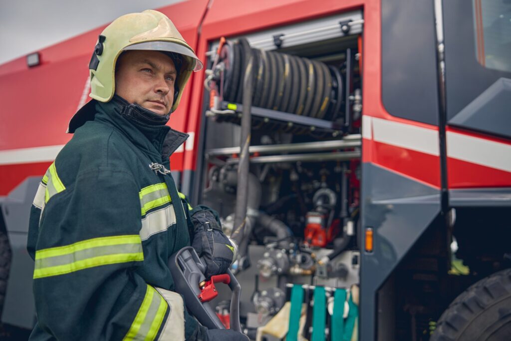 firefighter-is-standing-near-the-fire-truck-e1696820879954.jpg